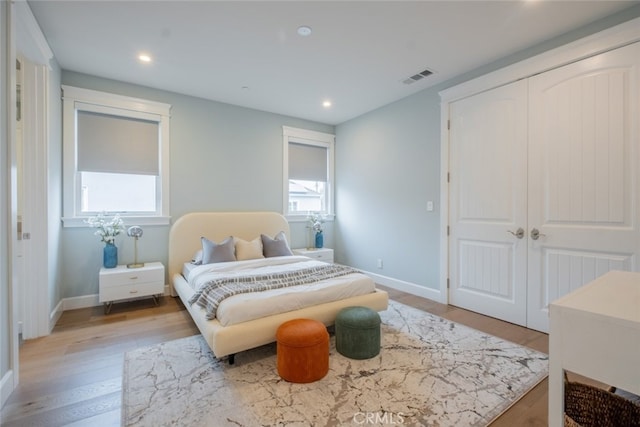 bedroom with recessed lighting, light wood-style floors, visible vents, and baseboards