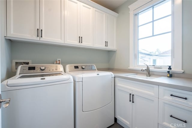 laundry area with a sink, cabinet space, and washing machine and clothes dryer