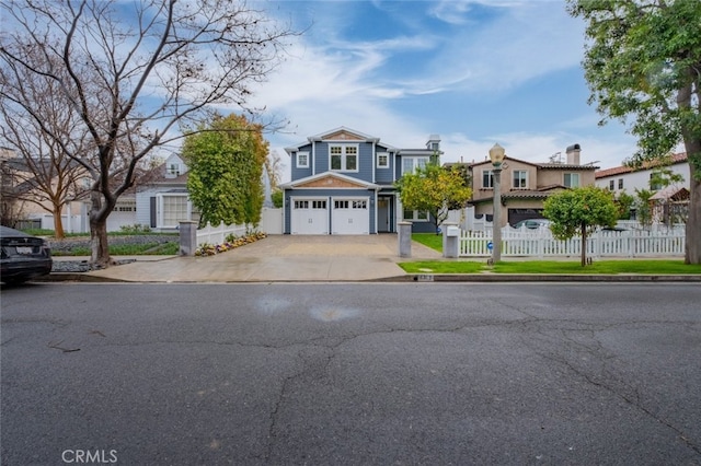 view of front facade with a garage, a residential view, concrete driveway, and fence