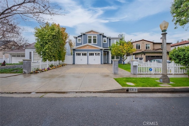 view of front of house with driveway, a garage, and fence