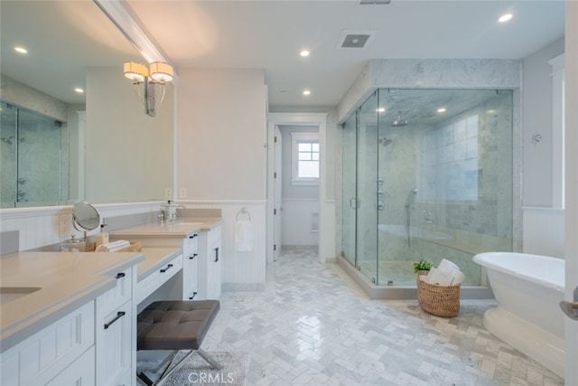 bathroom with recessed lighting, a freestanding tub, vanity, and a shower stall