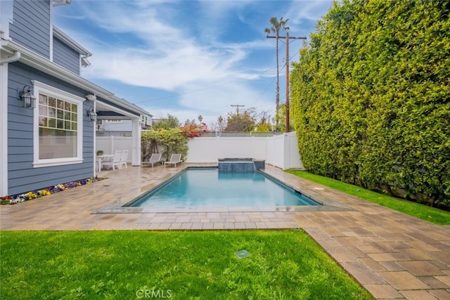 view of pool featuring a fenced backyard, a lawn, a pool with connected hot tub, and a patio