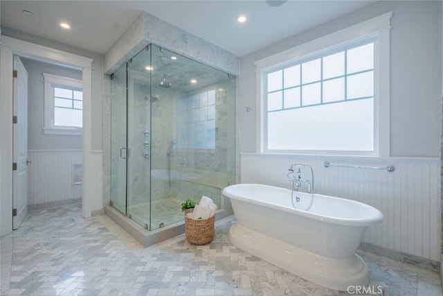 bathroom featuring a shower stall, recessed lighting, a wainscoted wall, and a freestanding bath