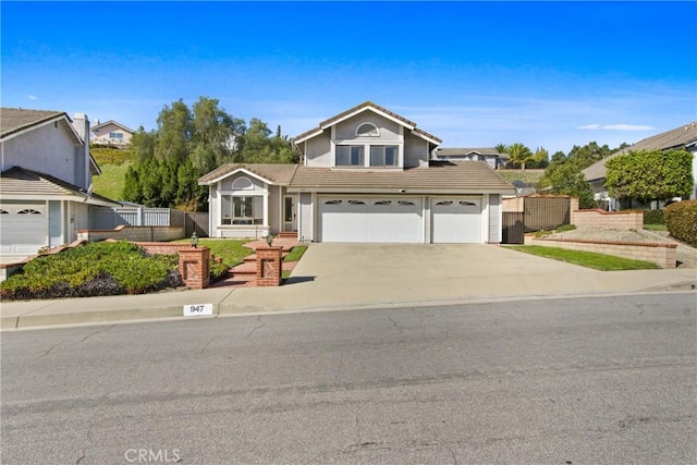 traditional-style house with a tiled roof, a garage, concrete driveway, and fence