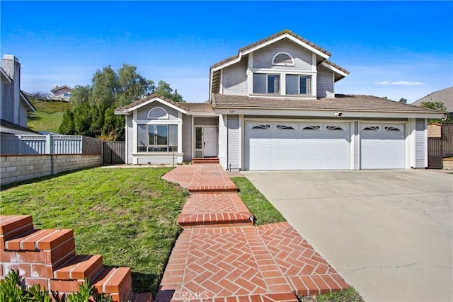 traditional-style house with a front yard, fence, driveway, an attached garage, and a tiled roof