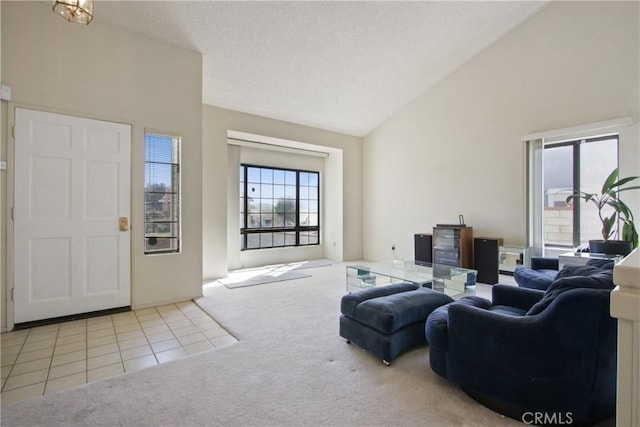 carpeted living room with tile patterned flooring, a textured ceiling, and high vaulted ceiling