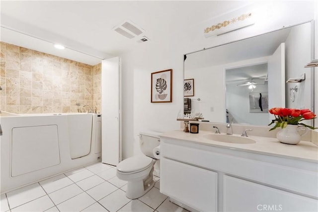 bathroom featuring vanity, a tub to relax in, visible vents, tile patterned flooring, and toilet