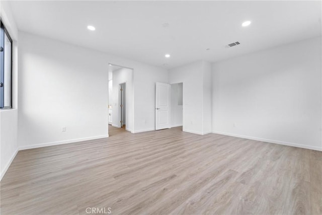 spare room with baseboards, recessed lighting, visible vents, and light wood-type flooring