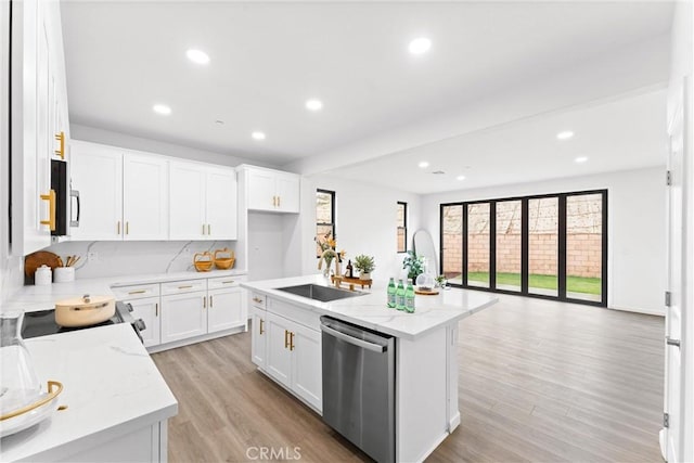 kitchen featuring recessed lighting, a sink, light wood-style floors, appliances with stainless steel finishes, and white cabinetry