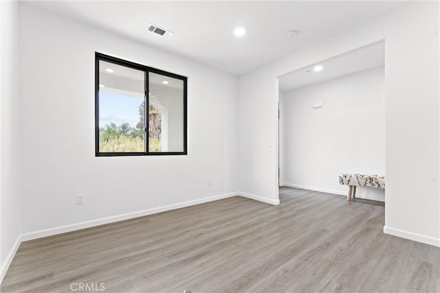 unfurnished room with recessed lighting, visible vents, baseboards, and light wood-style flooring