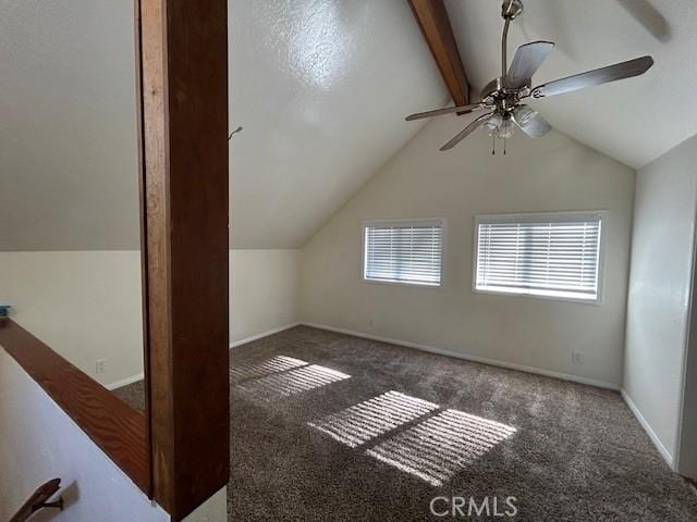 additional living space with lofted ceiling with beams, carpet flooring, a ceiling fan, and baseboards