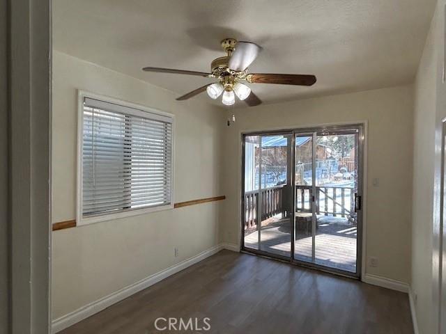 spare room with ceiling fan, baseboards, and wood finished floors