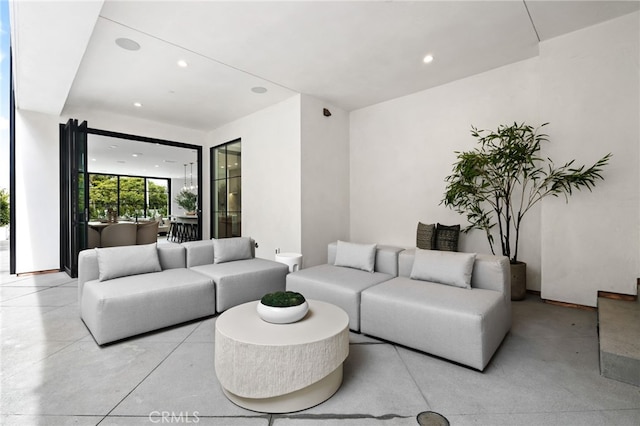 living area featuring recessed lighting and concrete flooring