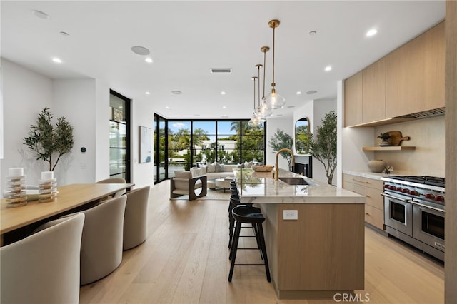 506 Avocado Ave, Corona Del Mar, CA 92625 - kitchen with modern cabinets, light brown cabinets, a sink, double oven range, and floor to ceiling windows