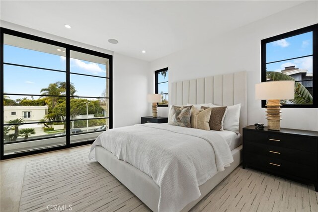 506 Avocado Ave, Corona Del Mar, CA 92625 - bedroom with access to exterior, recessed lighting, light wood finished floors, and expansive windows