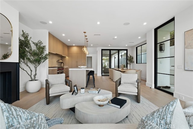 living area featuring recessed lighting, visible vents, and light wood-style flooring