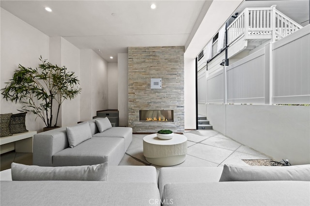 living area with stairway, recessed lighting, a fireplace, and light tile patterned flooring