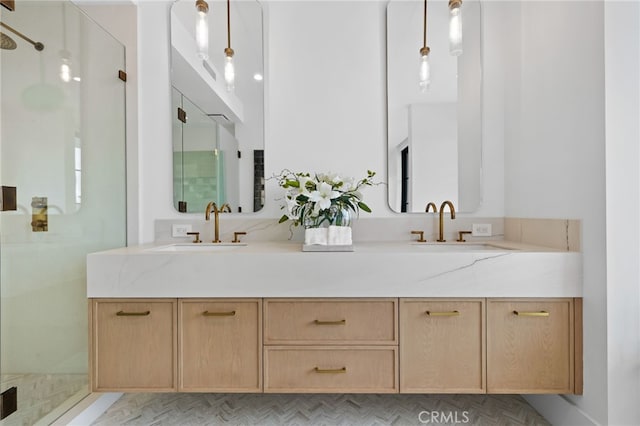 bathroom with double vanity, a stall shower, and a sink