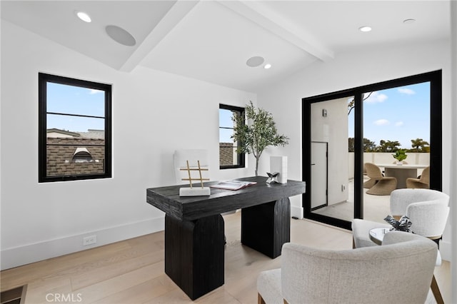 home office with light wood-style flooring, a healthy amount of sunlight, lofted ceiling with beams, and baseboards