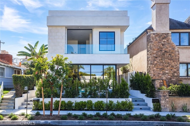 506 Avocado Ave, Corona Del Mar, CA 92625 - contemporary home featuring stucco siding, a chimney, and stairs