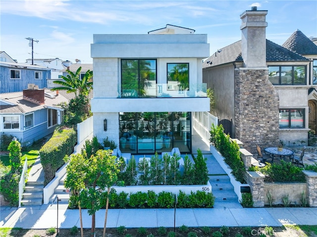 506 Avocado Ave, Corona Del Mar, CA 92625 - back of house featuring fence, stairway, stucco siding, a balcony, and stone siding