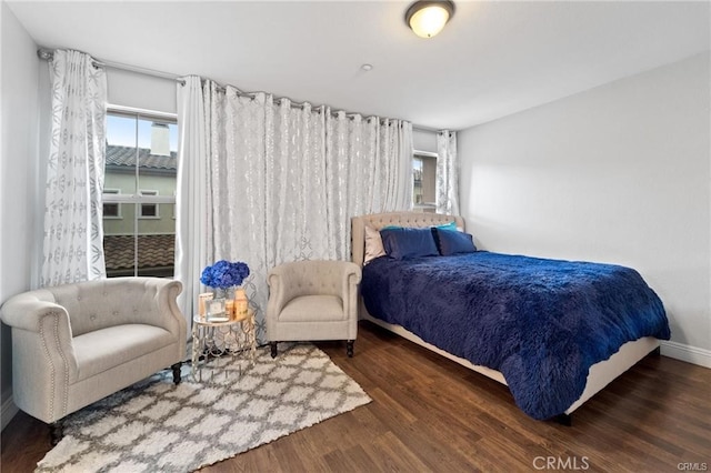 bedroom with wood finished floors and baseboards