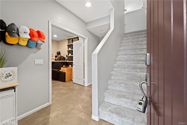 staircase featuring baseboards