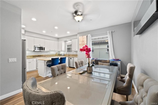 dining room featuring recessed lighting, baseboards, light wood finished floors, and ceiling fan