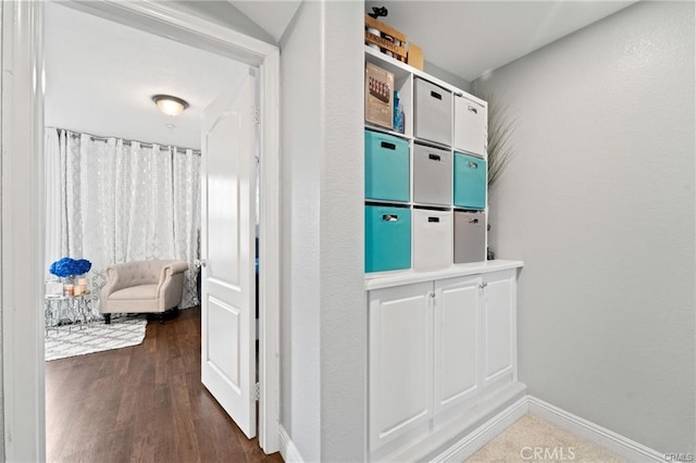 hall featuring dark wood finished floors and baseboards