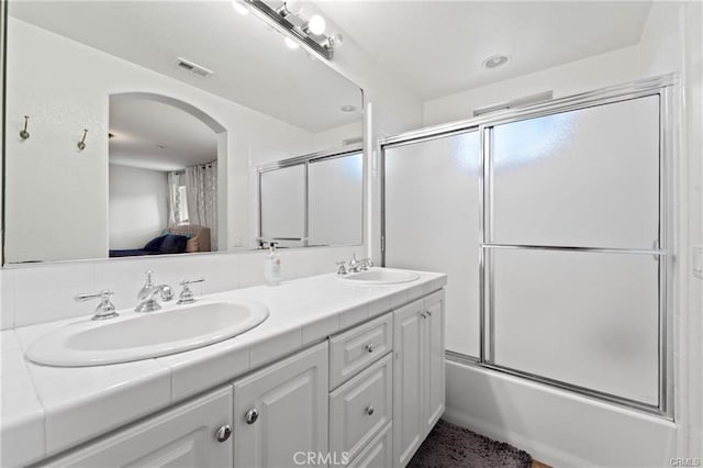 full bathroom featuring a sink, visible vents, double vanity, and ensuite bathroom