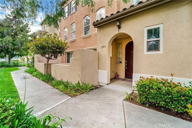 doorway to property with stucco siding