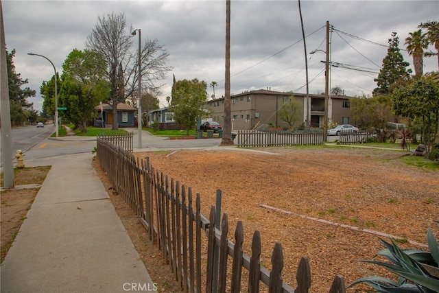 view of yard featuring a residential view and a fenced front yard