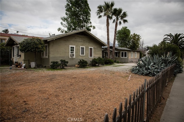 view of front of property featuring fence