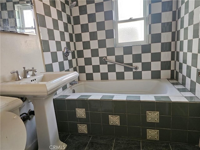 full bathroom featuring tiled shower / bath combo, toilet, and a healthy amount of sunlight