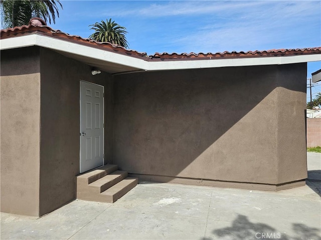 view of exterior entry with stucco siding