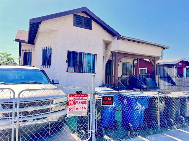 view of front of property with stucco siding and fence