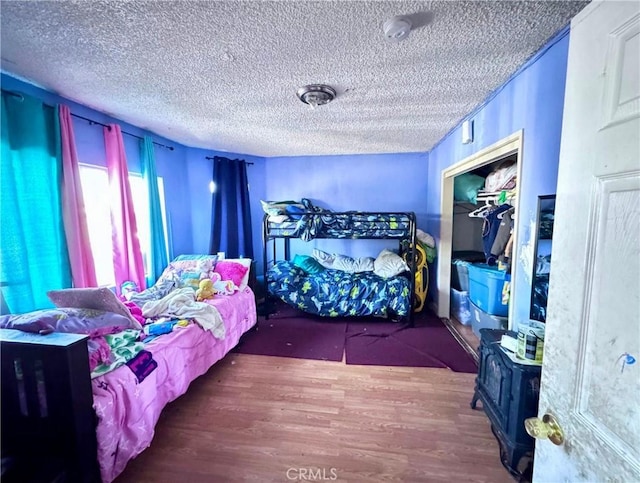 bedroom featuring a textured ceiling and wood finished floors