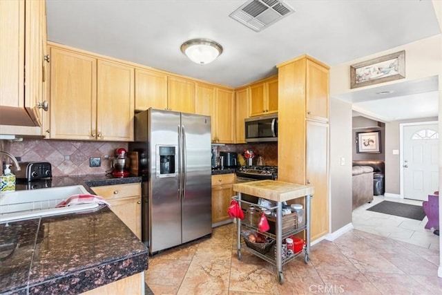 kitchen featuring visible vents, light brown cabinetry, tasteful backsplash, stainless steel appliances, and tile counters