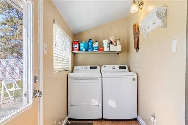 laundry room with baseboards, laundry area, and washing machine and clothes dryer