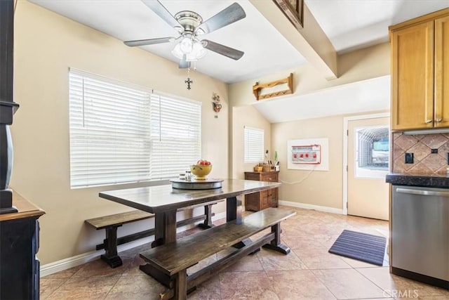 dining area with a ceiling fan, a healthy amount of sunlight, and baseboards