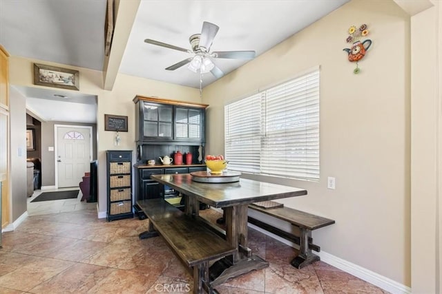 dining area featuring a ceiling fan and baseboards