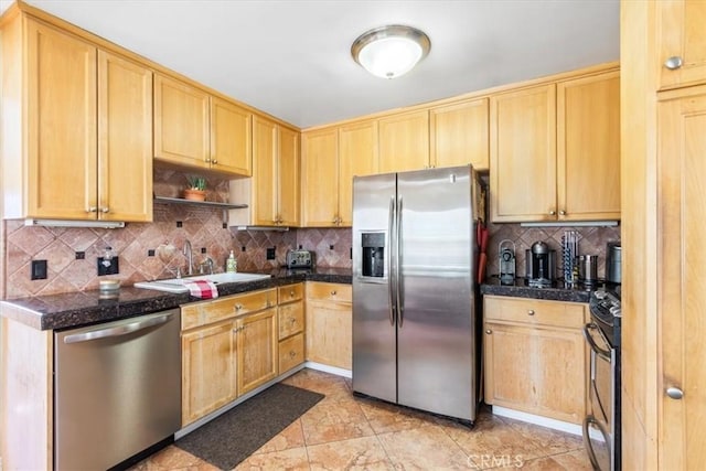 kitchen featuring a sink, stainless steel appliances, and light brown cabinetry