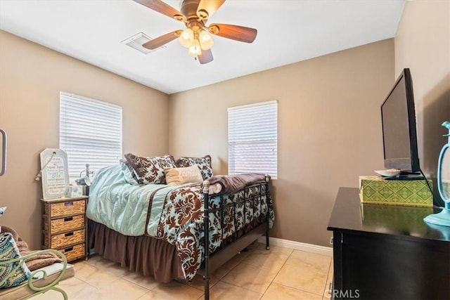 bedroom featuring baseboards, light tile patterned flooring, and a ceiling fan