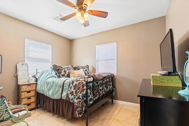 5238 W W Ave L6, Lancaster, CA 93536 - bedroom featuring multiple windows, light tile patterned floors, a ceiling fan, and baseboards