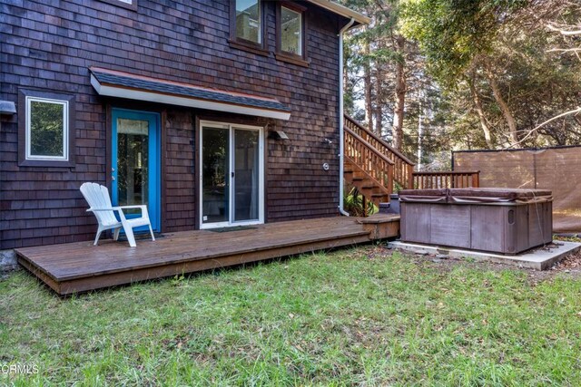 exterior space featuring a lawn, fence, and a hot tub