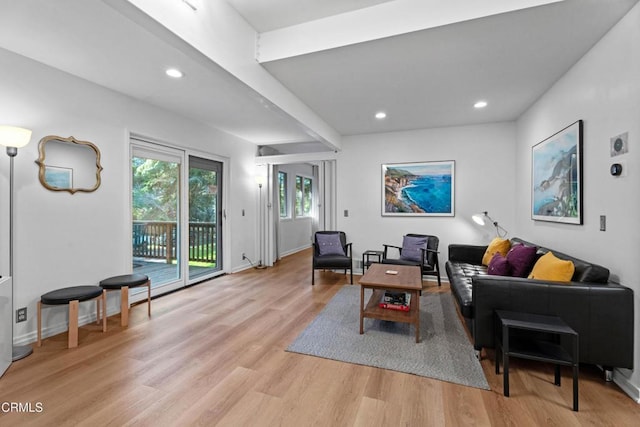 living area with recessed lighting, light wood-style floors, and baseboards