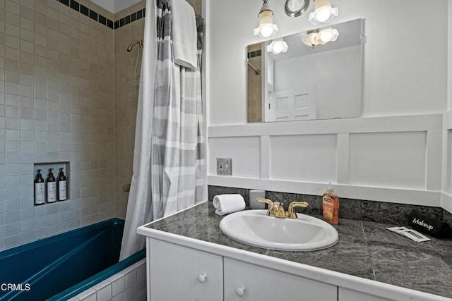 bathroom featuring vanity and tiled shower / bath combo