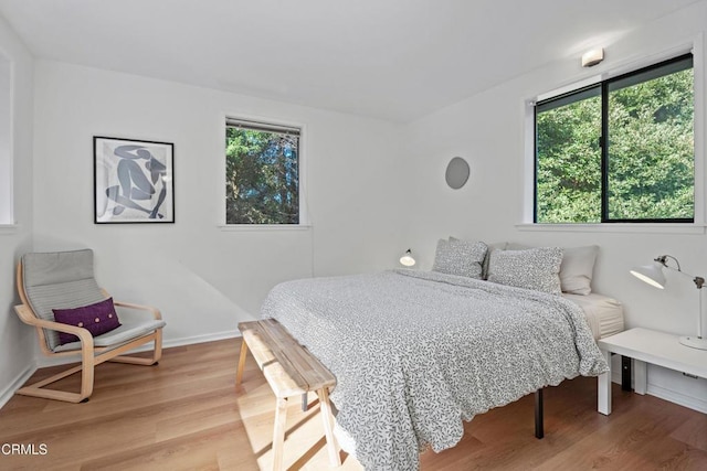 bedroom featuring baseboards and light wood-style flooring