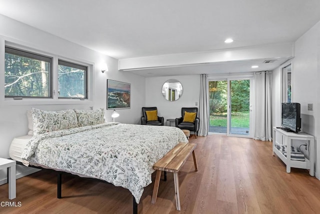 bedroom featuring recessed lighting, wood finished floors, and access to exterior