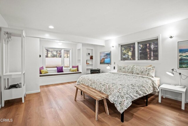 bedroom with recessed lighting, baseboards, and wood finished floors